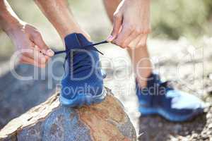 Im not going to mess this up. Closeup shot of an unrecognisable man tying his shoelaces while exercising outdoors.