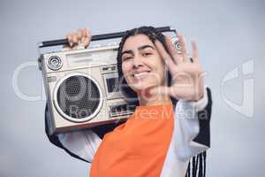 Talk to the hand. a beautiful young woman holding a boombox.