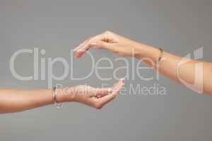 Friendship is all about balance. two unrecognizable women posing with their hands cupped above each other.