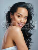 Say hello to fabulous hair. Studio portrait of an attractive young woman posing against a grey background.