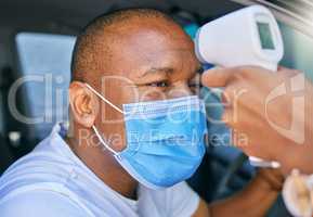 Fever, temperature and Covid test at drive through station in a car. Screening patient with protective mask with a digital thermometer. Wellness and safety of people through a pandemic