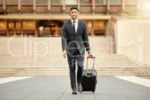 Ive got important places to go. a businessman walking around town with his luggage.