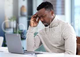 Trying to make sense of a new business proposal. a young businessman looking confused while working on a laptop in an office.