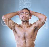 Running a flutter as soon as things get to clutter. Studio shot of a handsome young man washing his hair in a shower against a grey background.