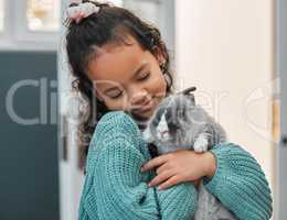 Hello there Mr Rabbit. an adorable little girl bonding with her pet rabbit at home.