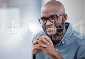 You may only succeed if you desire succeeding. a young businessman using a laptop in a modern office.