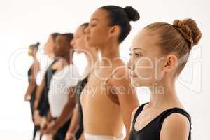 Consciousness expresses itself through creation. a group of ballet dancers practicing a routine in a dance studio.