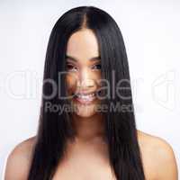 A fringe thats perfectly framed. an attractive young woman standing alone in the studio.