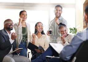 You never fail to impress. a diverse group of businesspeople cheering while sitting in the boardroom during a meeting.