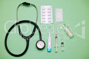 A doctor knows just what you need. medical equipment against a green background.