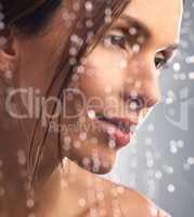 Good hygiene is the foundation of vibrant skin. Studio shot of a beautiful young woman taking a shower against a grey background.