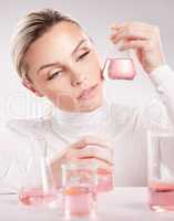 I think confidence is a true form of beauty. Studio shot of young woman making a potion against a white background.