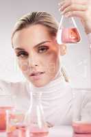 Shes a woman like few. Studio shot of young woman making a potion against a white background.