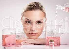 A beautiful woman can be painted as a totem only. Studio shot of young woman making a potion against a white background.