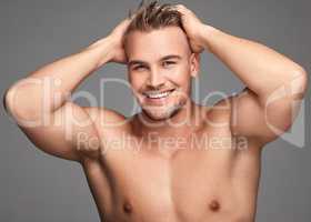 Feeling fresh and looking fine. Studio shot of a handsome young man posing against a grey background.