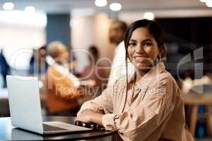 Ambition is the starting point of success. a young businesswoman using a laptop at a conference.