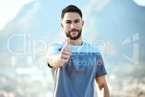 Workout and eat well - your body will then reward you. Portrait of a sporty young man showing thumbs up while exercising outdoors.