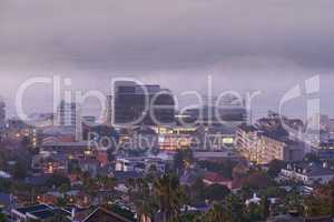 Cape Town. City view of building lights on a cold winter day. Outdoor, streets and architectural detail around foggy background in a town. Tall palm trees, life in an urban coastal town.