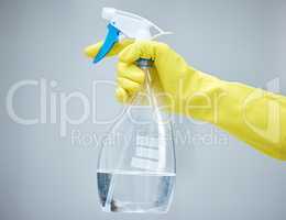 Keep your home safe and clean. a hand holding a spray bottle and wearing yellow gloves.