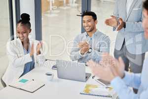 Its no wonder their work is well known. businesspeople clapping hands in a boardroom at work.