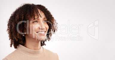 Let yourself wonder. an attractive young woman looking thoughtful in studio against a grey background.