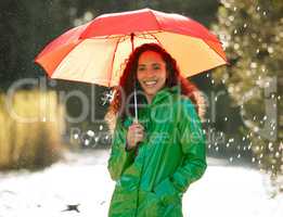 A relaxing walk in the rain does wonders for the soul. a beautiful young woman spending a day outside in the rain.