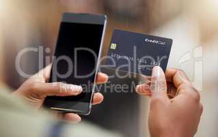 Never missing another payment. a young woman using her smartphone to make card payments.