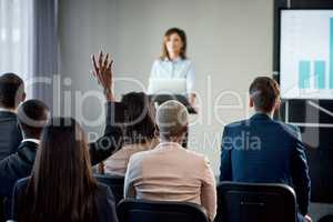 Innocence is ignorance before its introduced to currency and clips. Rearview shot of a group of businesspeople attending a conference.