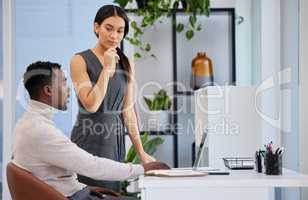 So what are your thoughts. two businesspeople working together on a laptop in an office.