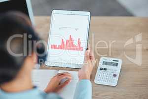 Financial advisor reading and studying finance data charts, graphs and reports on tablet in office. Above view of professional holding, analyzing and calculating profit and loss information