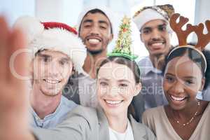 Its the best time of the year. a group of businesspeople taking a selfie at work.