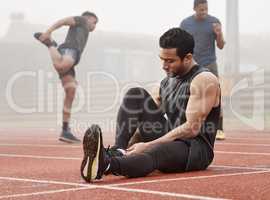 Switching into sport mode. a young male athlete adjusting his leggings before a run.