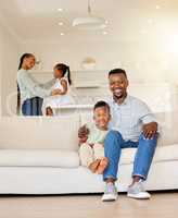 Portrait of happy African American family relaxing, bonding and spending free time together at home. Carefree parents enjoying the weekend with their kids, looking content and peaceful in the lounge
