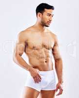 Feeling sensual and sexy. a man posing in his underwear against a white studio background.