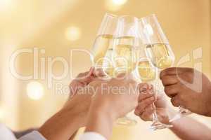 Cheers to another successful year. Closeup shot of a group of unrecognisable businesspeople toasting with wine at work.