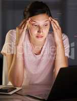 All the words are starting to blur together. a young woman looking stressed as she studies.