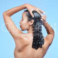 No need for validation, I am woman. a beautiful young woman enjoying a refreshing shower against a blue background.