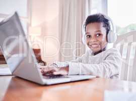 Learning is a lifelong process. a young boy doing his homework on a laptop at home.