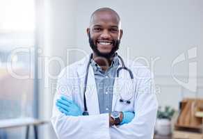 Just a smile already makes the patient feel better. a confident male doctor standing with his arms crossed.