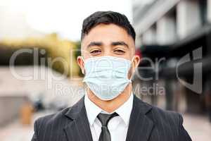 Be safe when youre outside. a young businessman wearing a protective face mask.