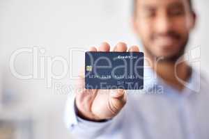 Buying, shopping and banking with a credit card or making payment, orders or bank loans. One person holding, showing and displaying a debit card to use for purchasing items, retail therapy and paying
