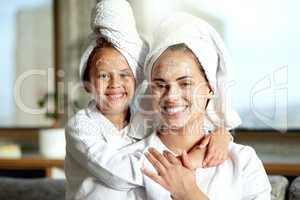 Facial, beauty and skincare at a spa for a bonding mother and daughter. Portrait of a cheerful, loving and joyful little girl enjoying a relaxing pamper session together with her mom or single parent