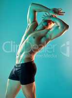 The human body is the best work of art. Studio shot of a handsome young man posing against a blue background.