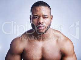 Rinse off yesterday, splash on today. Studio shot of a handsome young man washing his face against a blue background.