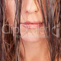 Can you wait to see my twisted smile. a young woman showing her luscious lips and wet hair.