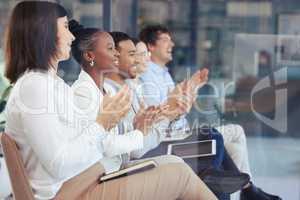 That deserves an applause. a group of businesspeople clapping in an office at work.