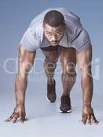 Be the one who went for it. Full length shot of a handsome young man crouched in a starters position in the studio.