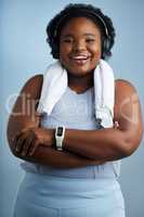 Getting fitter has lifted my spirits. Studio portrait of an athletic young woman standing with her arms folded against a blue background.