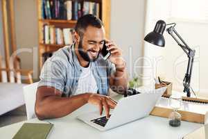 Its been ages since we last spoke. a handsome businessman using his smartphone to make a phonecall while working from home.