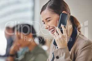 Creating a personal connection with her customers. a young businesswoman talking on a telephone while working in a call centre.